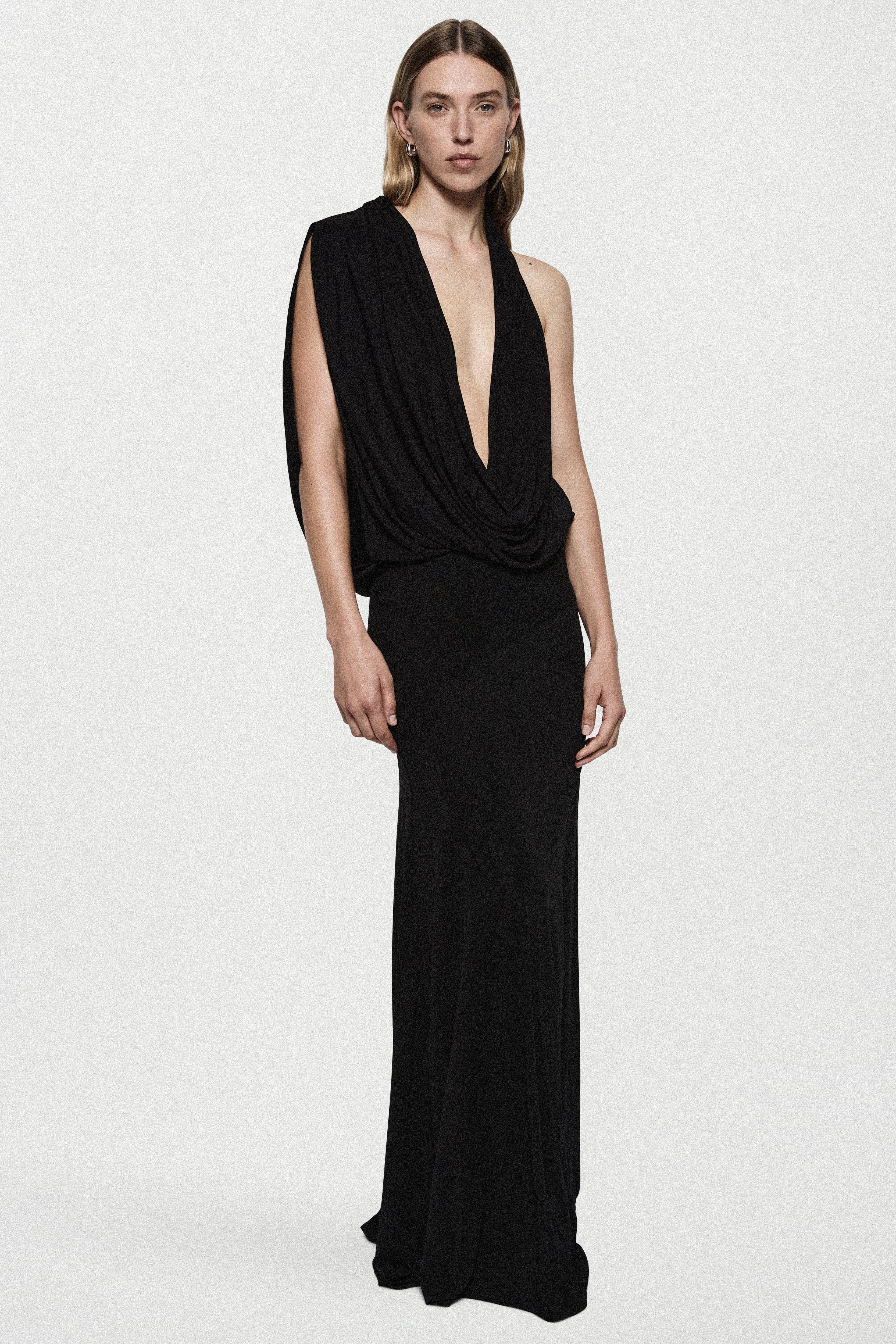 Black sleeveless jersey cowl gown with draped V neckline and floor-length column skirt