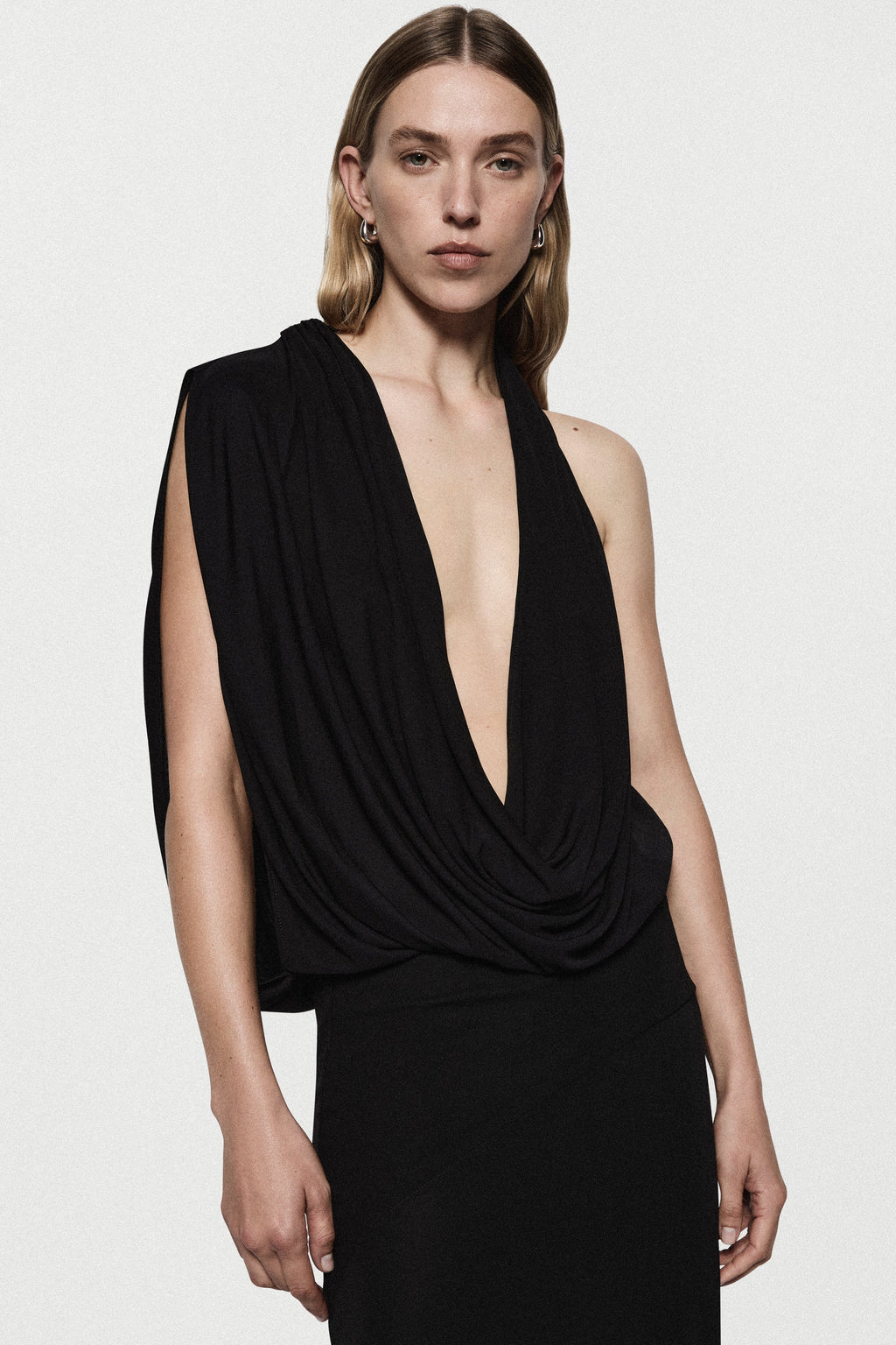 Black sleeveless cowl gown with deep V drape and wrap-style neckline, fitted bodice