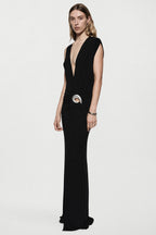 Black sleeveless plunging maxi dress with draped front and silver ring belt