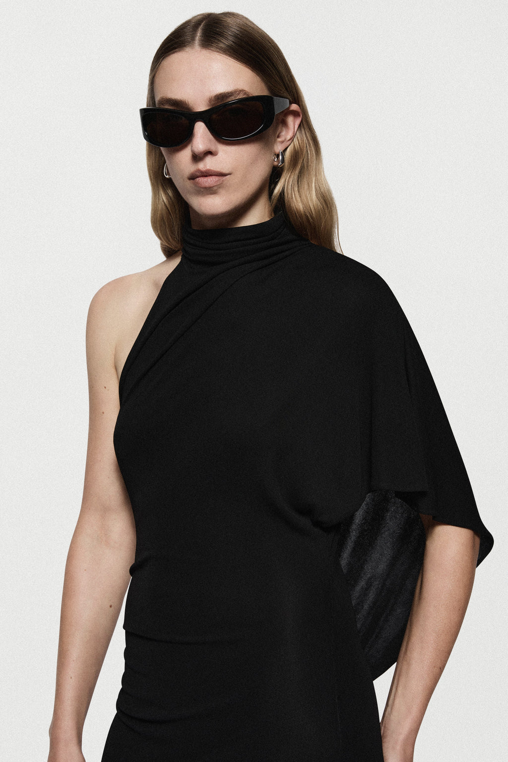 Black jersey high-neck dress with draped cape sleeve detail