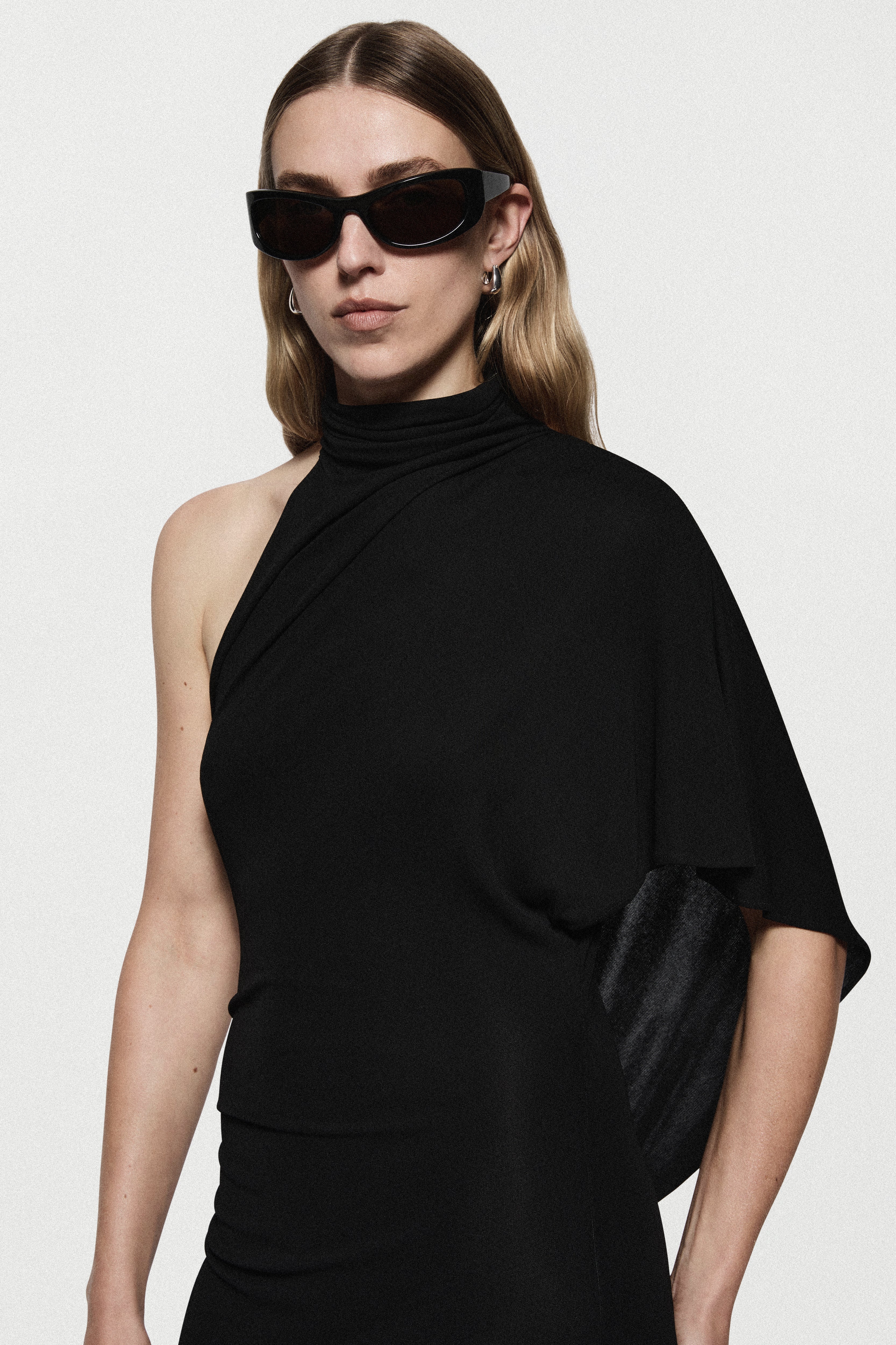 Black jersey high-neck dress with draped cape sleeve detail