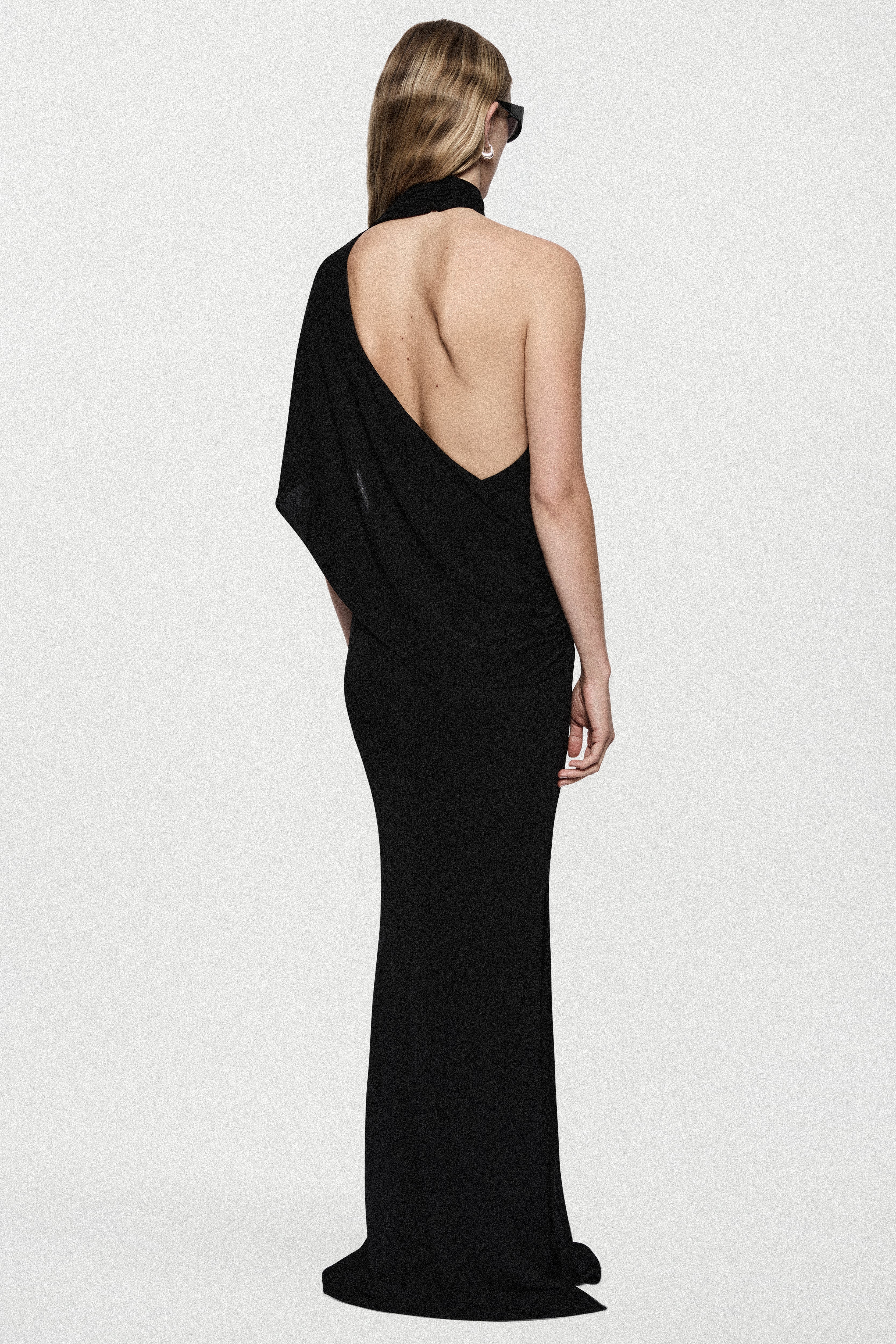Black jersey maxi dress with draped cape detail and open back