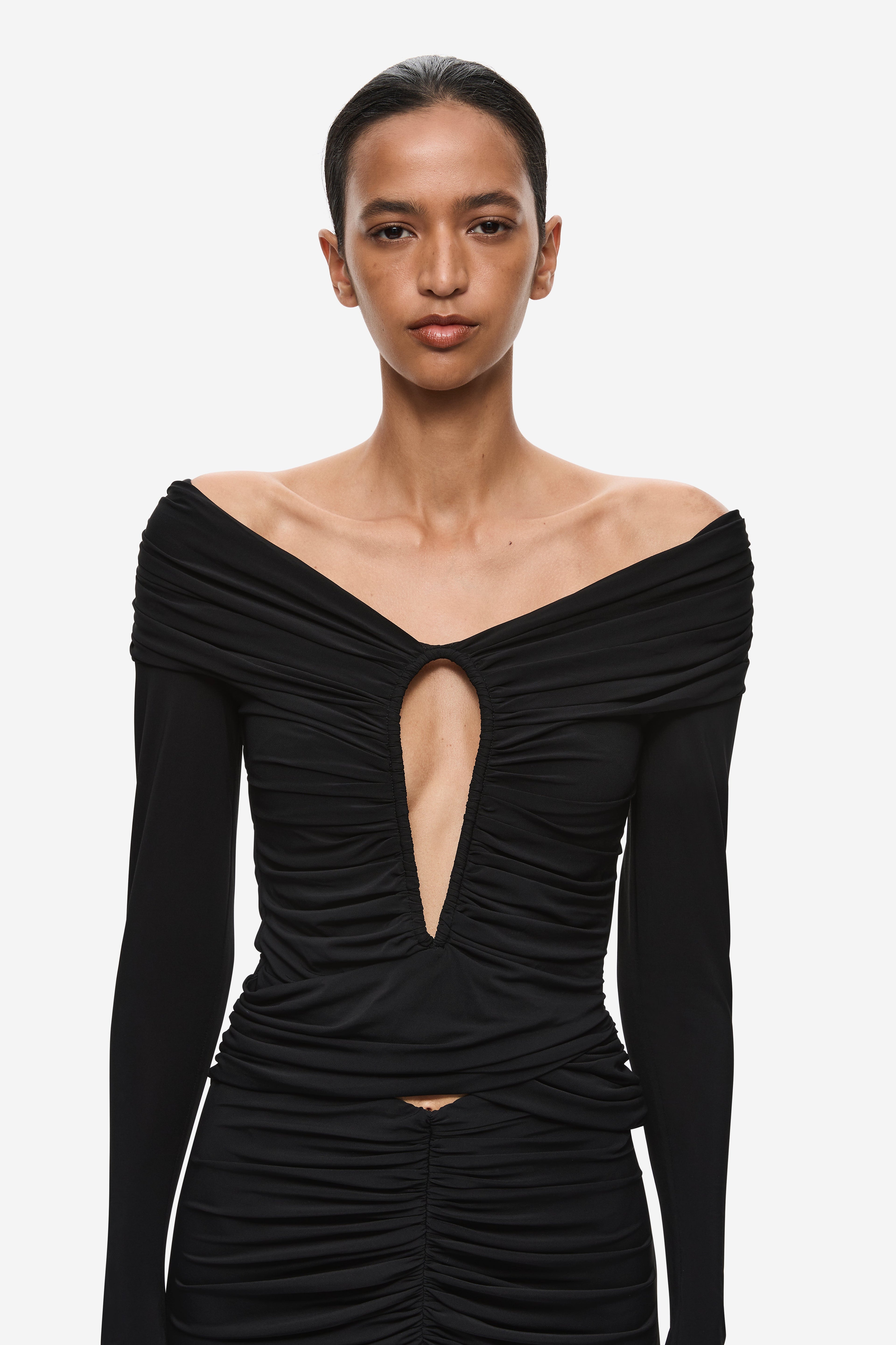 Black off-shoulder ruched top with vertical keyhole cutout and long sleeves