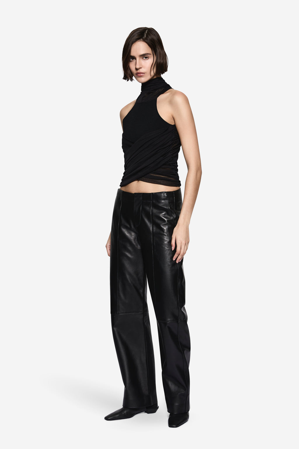 Black knit halter top with twisted drape front, sleeveless and high neck