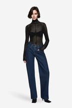 Black fitted open-knit long sleeve turtleneck top with dotted grid pattern