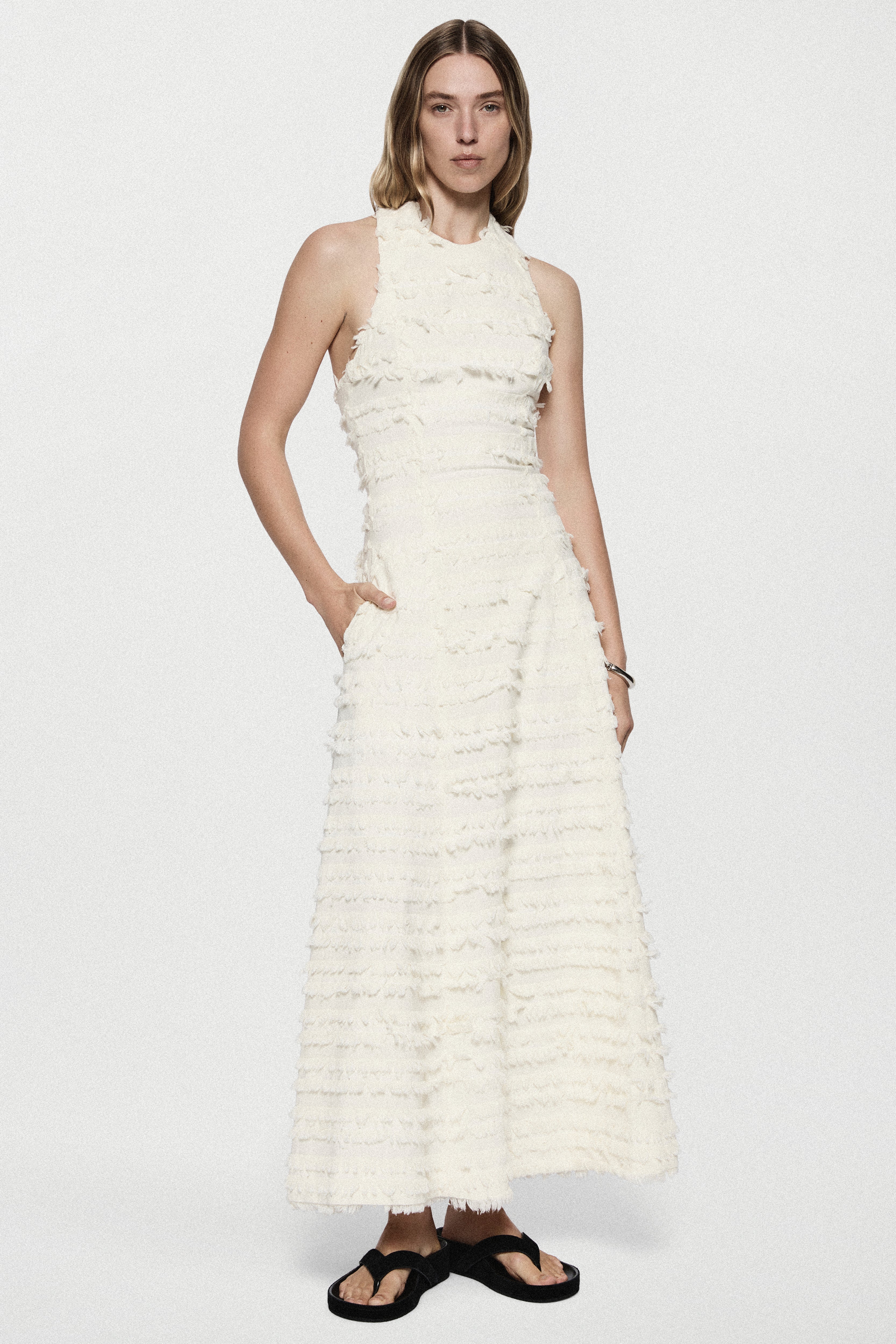 Winter white cotton fringe dress, sleeveless tiered ruffles, front view
