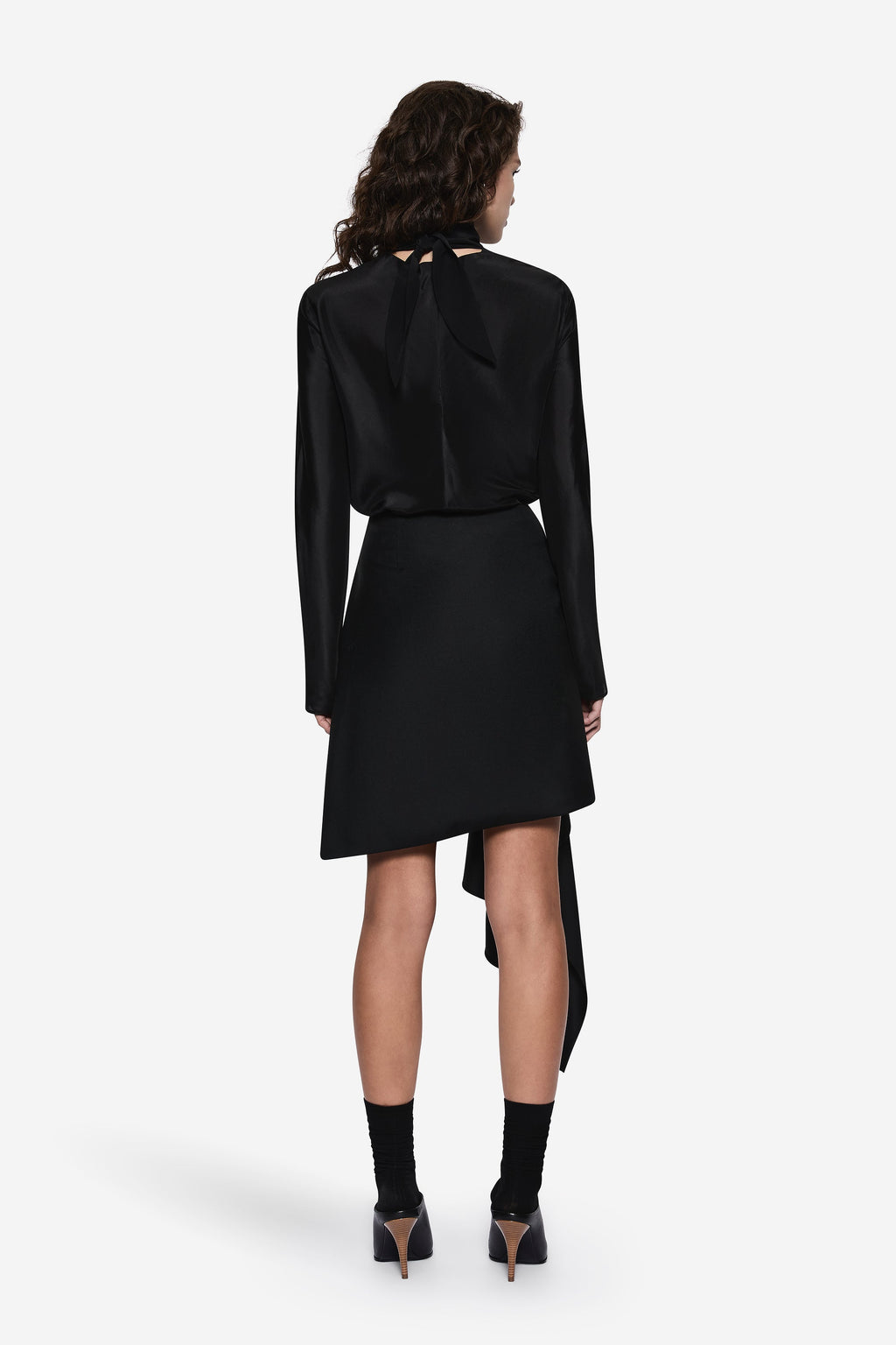 Black sheer silk blouse with long sleeves and draped asymmetric back hem