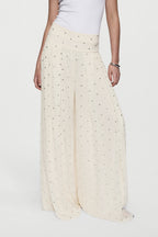 Winter white rhinestone palazzo pants with elastic waistband and flowing wide-leg fit