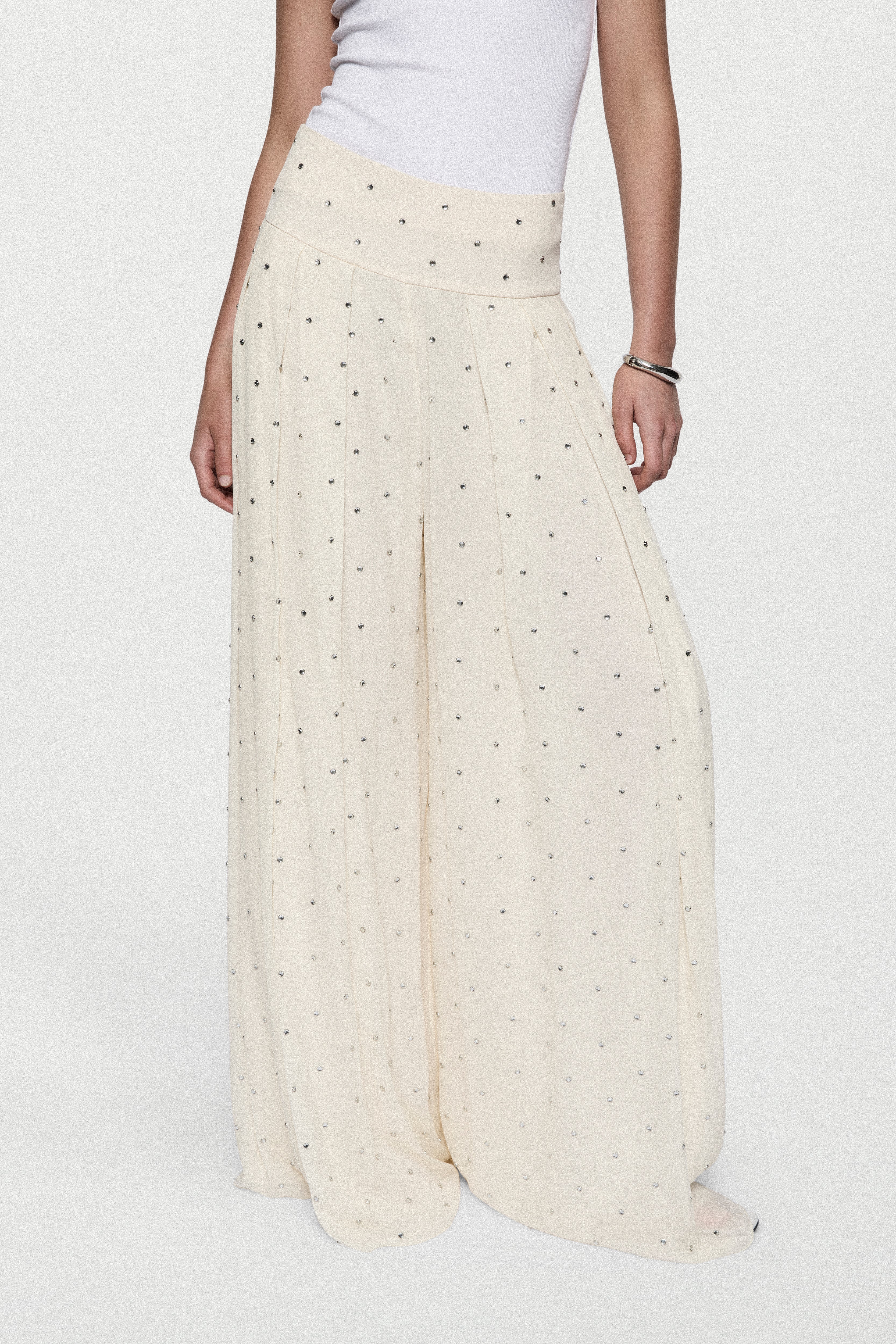 Winter white rhinestone palazzo pants with elastic waistband and flowing wide-leg fit