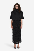 Black short-sleeve turtleneck tee and patterned black lace midi skirt