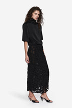 Black short-sleeve turtleneck tee with patterned black lace pencil midi skirt