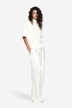 White acetate tee with high mock neck and short sleeves, side drape detail