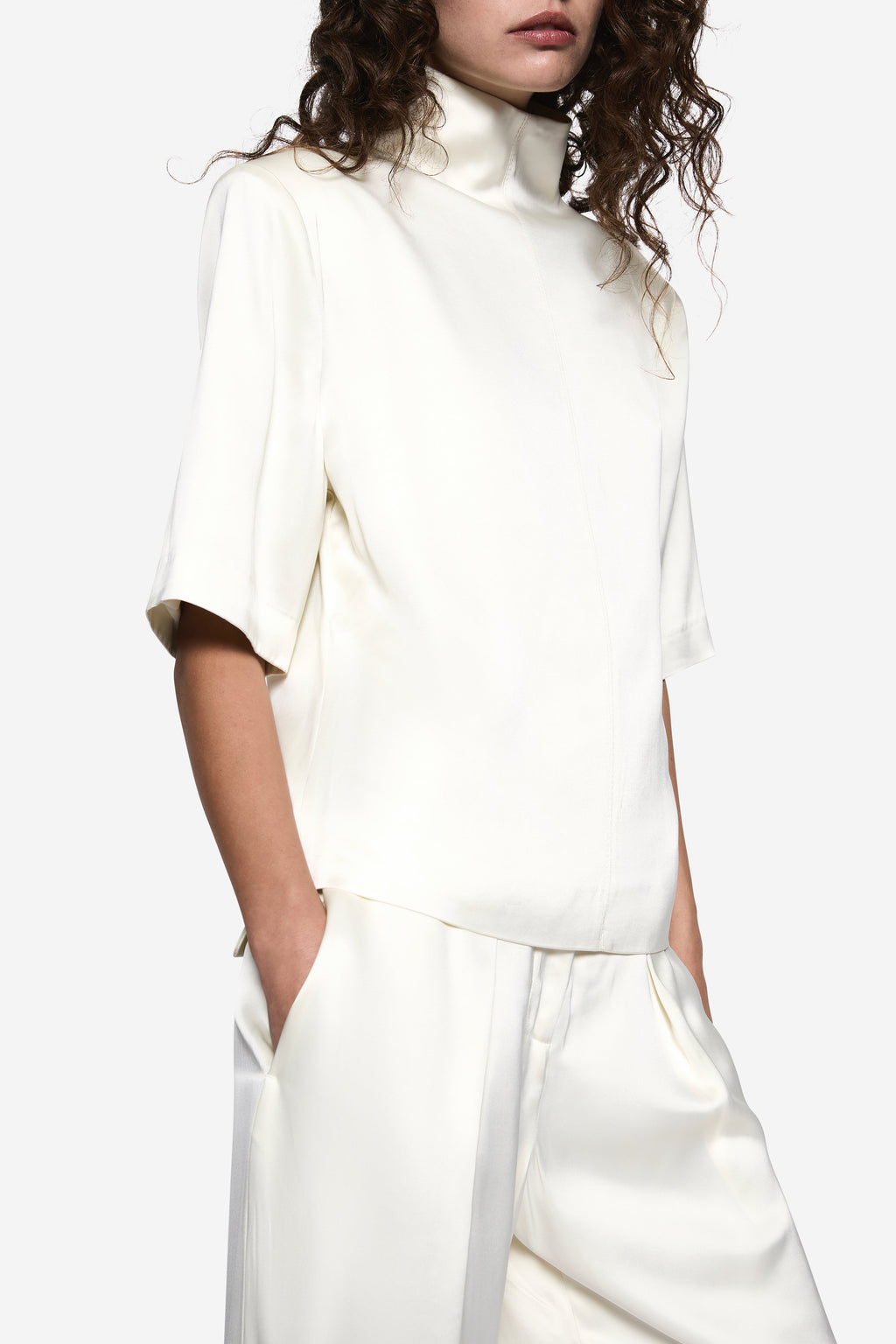 White acetate tee with high mock neck and short sleeves, front seam detail