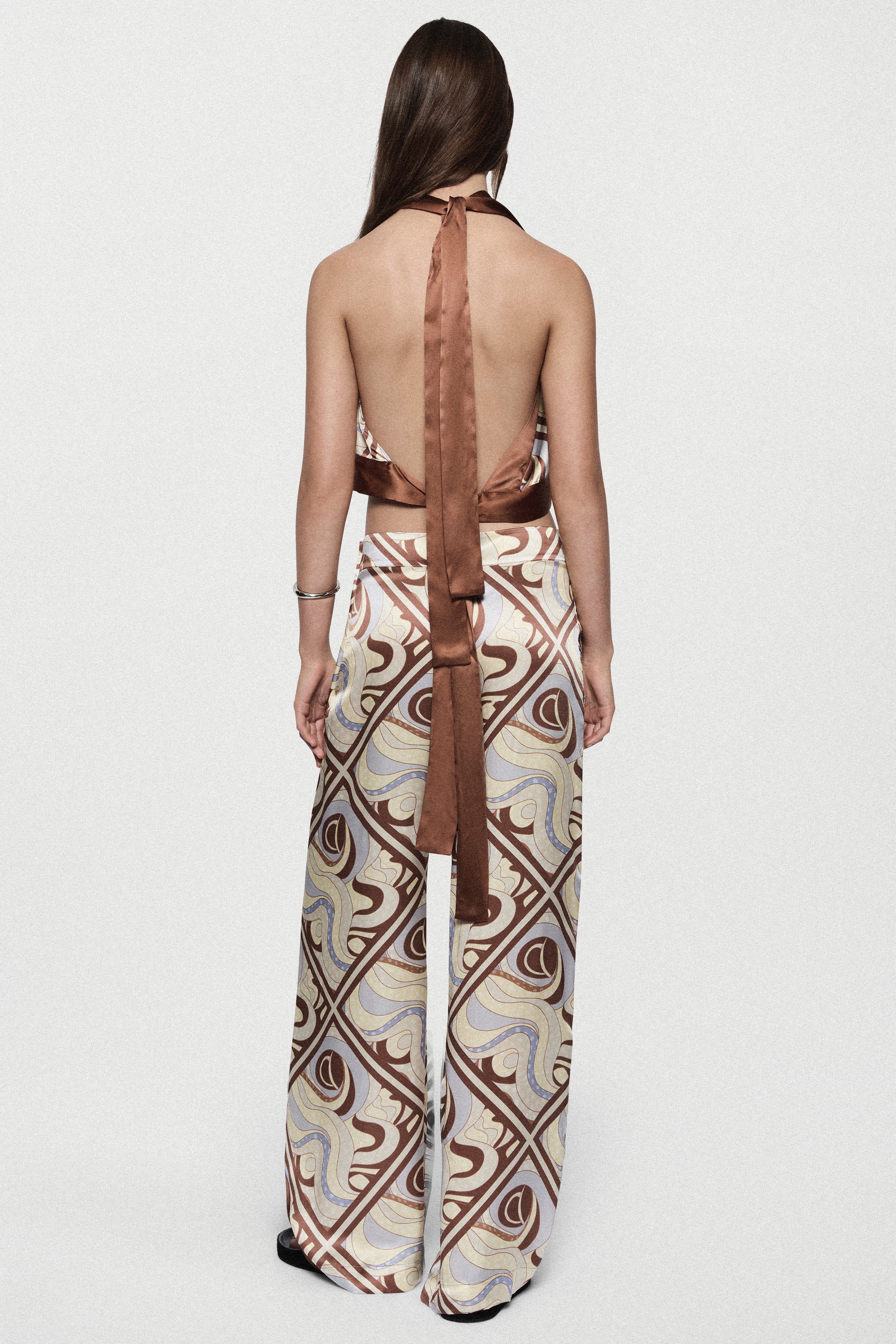 Silk trousers with LAGO swirl print, back drape and wide-leg flared cut