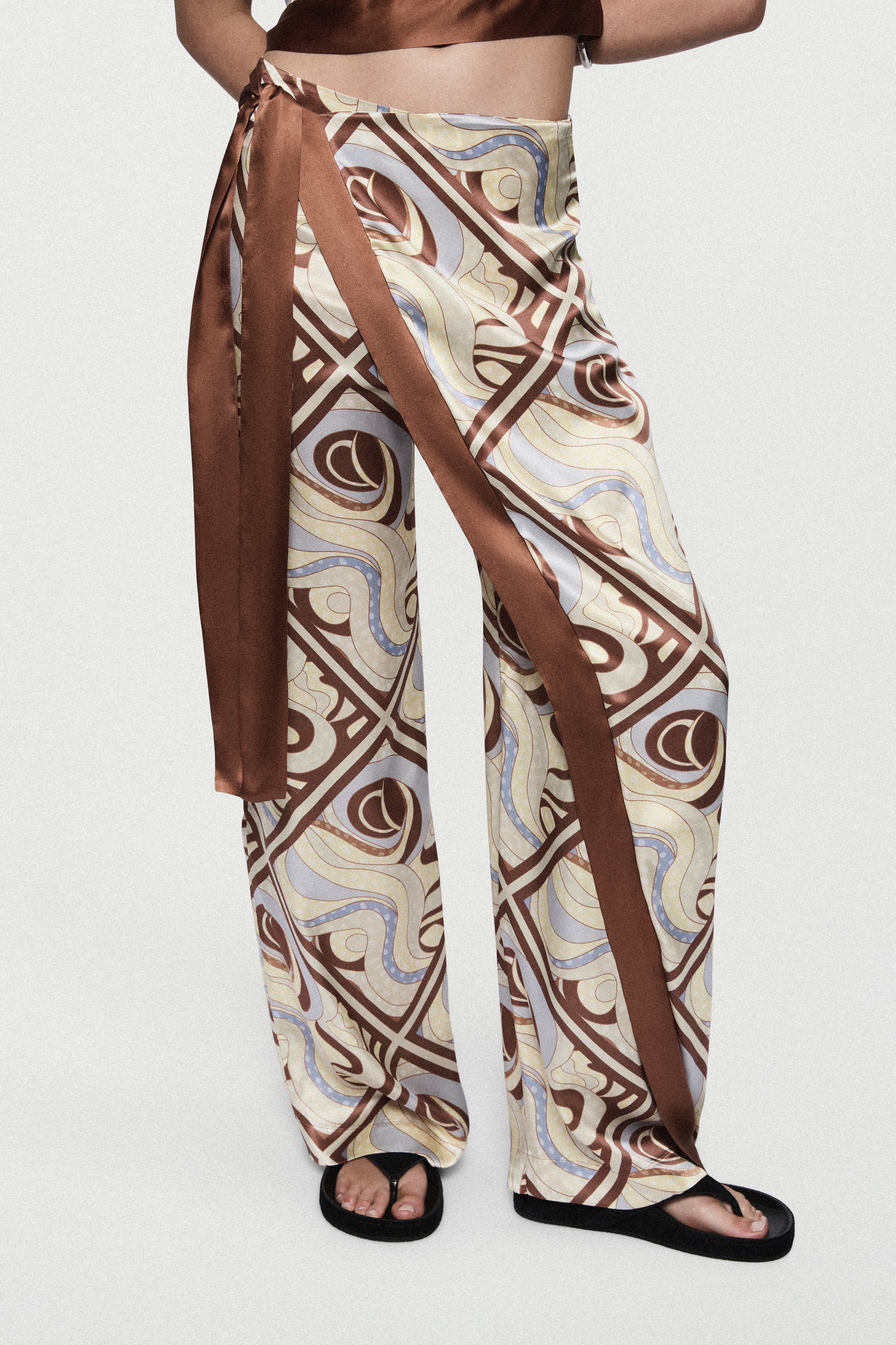 Silk trousers with LAGO swirl print, wide-leg cut with long side sash