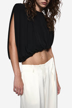 Black sleeveless draped jersey top with gathered waist seam and soft folds