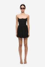 Black gathered jersey mini skirt with elastic waistband and finely pleated texture.