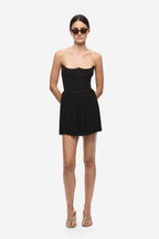 Black gathered jersey mini skirt with elastic waistband and pleated, gathered hem.