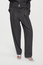 Charcoal tailored trousers with zip fly, pleated front, and tapered leg