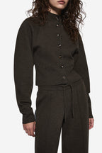 Hunter green knit cardigan close-up, button placket and ribbed hem