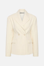Cream blazer front view with notched lapels, flap pockets, and two-button closure.