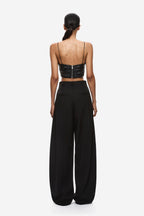 Black wide-leg trousers, back view, high waist pleats