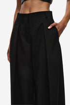 Black high-waist pleated trousers with soft gathered shaping