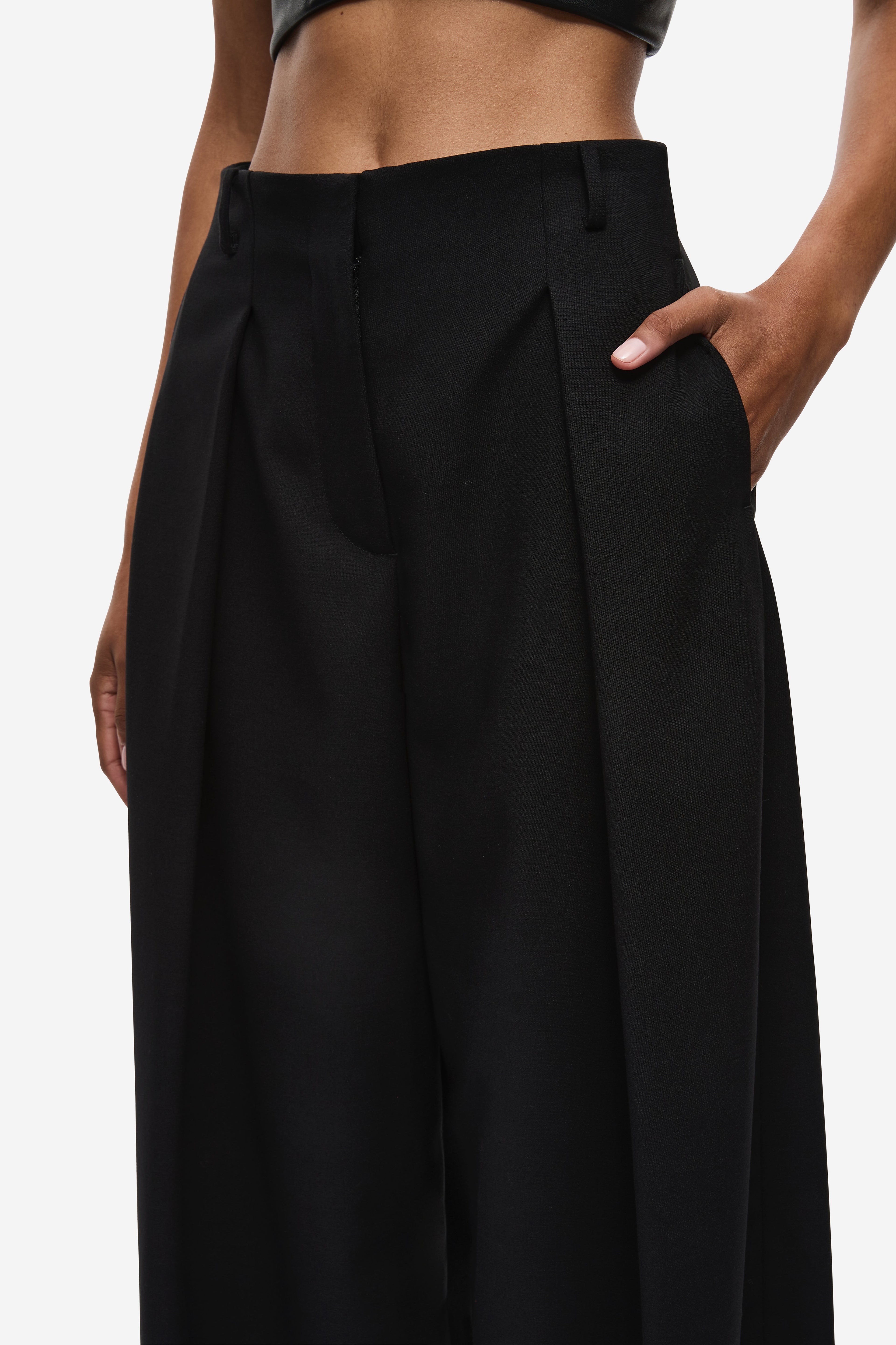 Black high-waist pleated trousers with soft gathered shaping