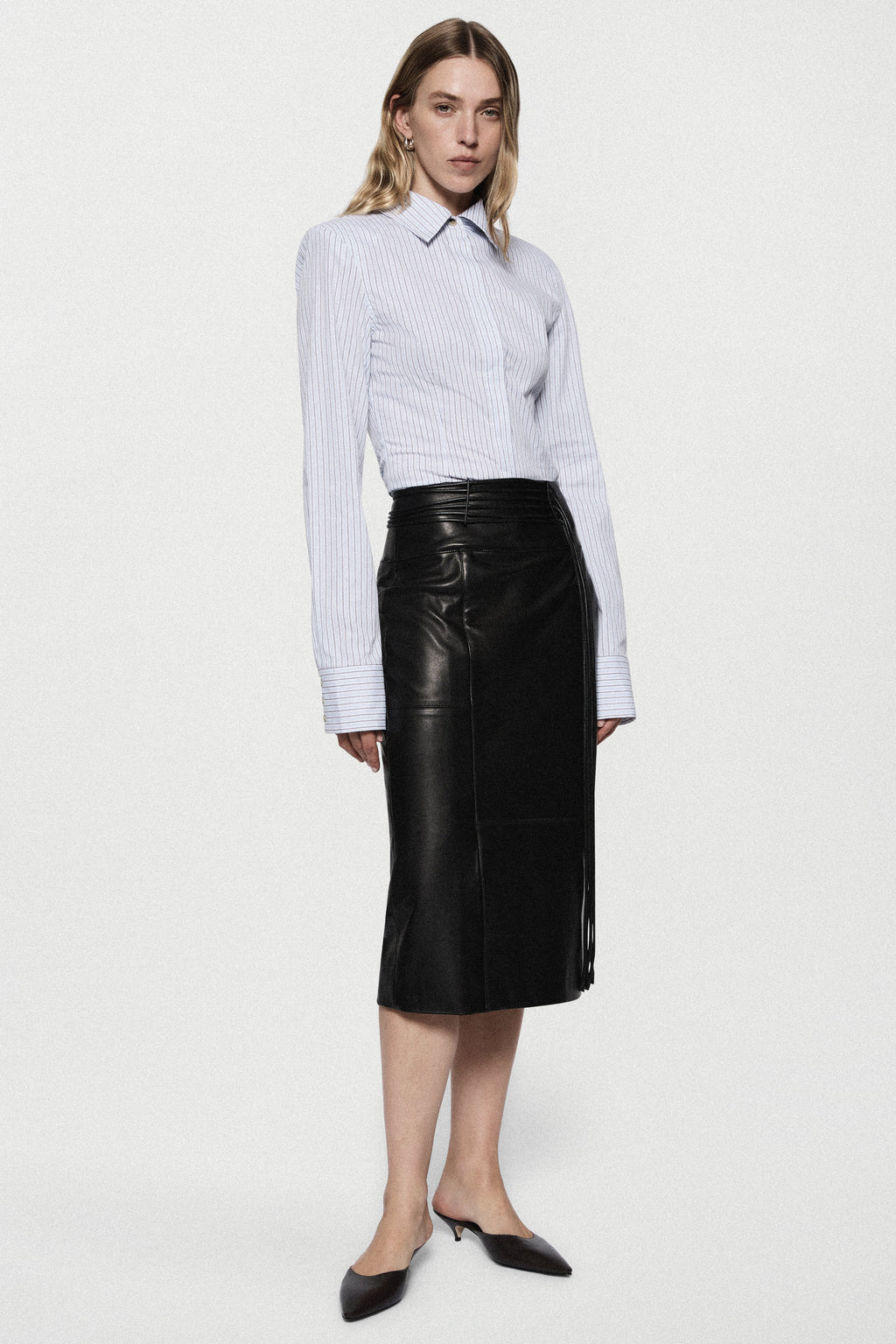 Black leather midi pencil skirt with high waistband and straight, fitted silhouette