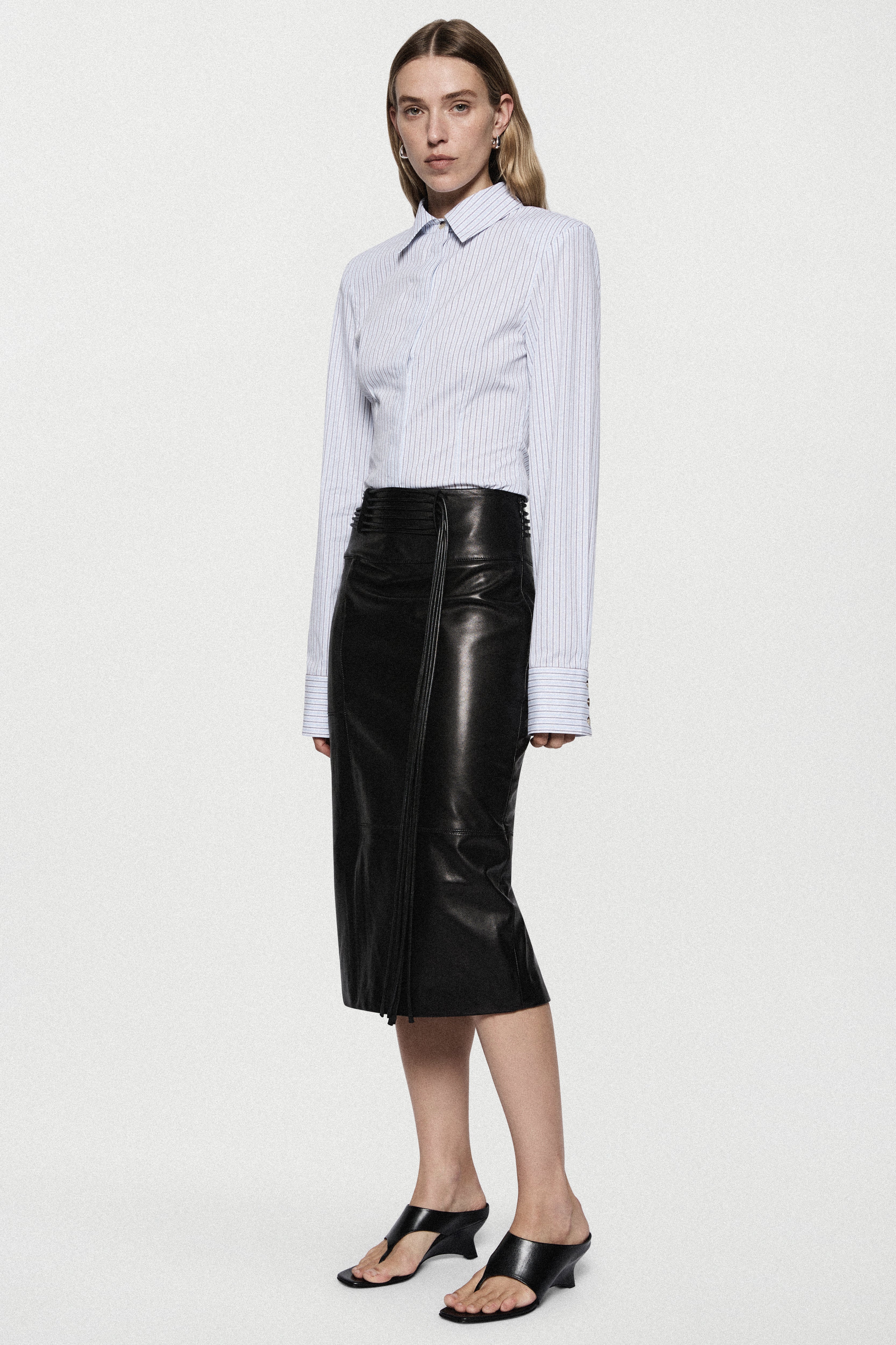 Light blue vertical striped button-up shirt with pointed collar and long sleeves