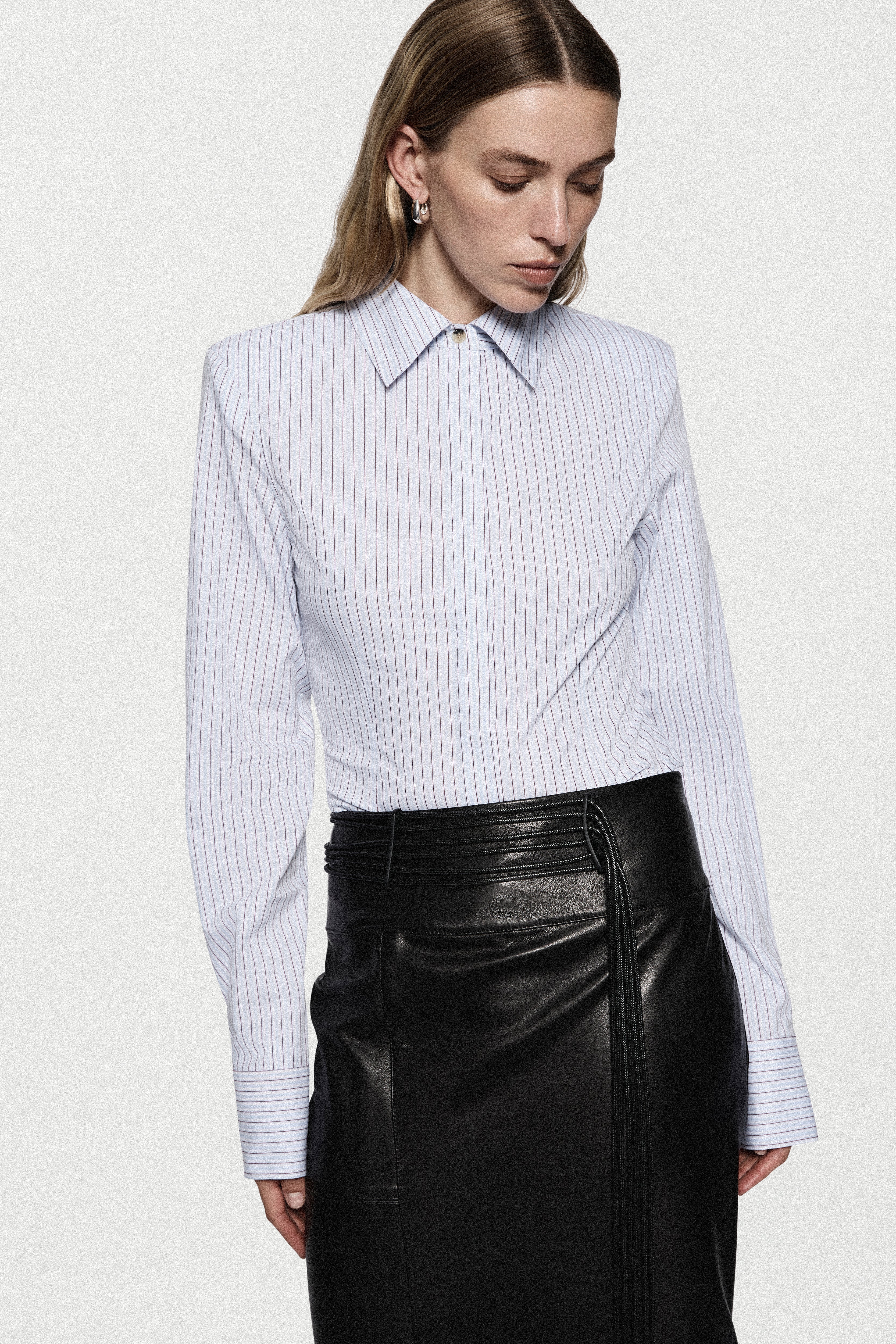 Light blue vertical striped fitted button-up shirt with pointed collar and long sleeves