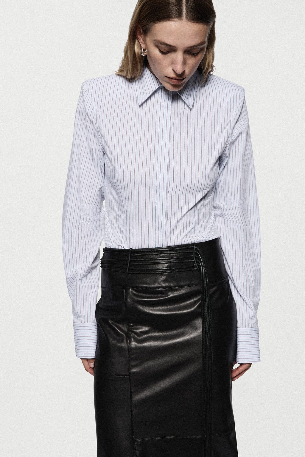 Black leather midi pencil skirt with high waistband and stitched front seam detail