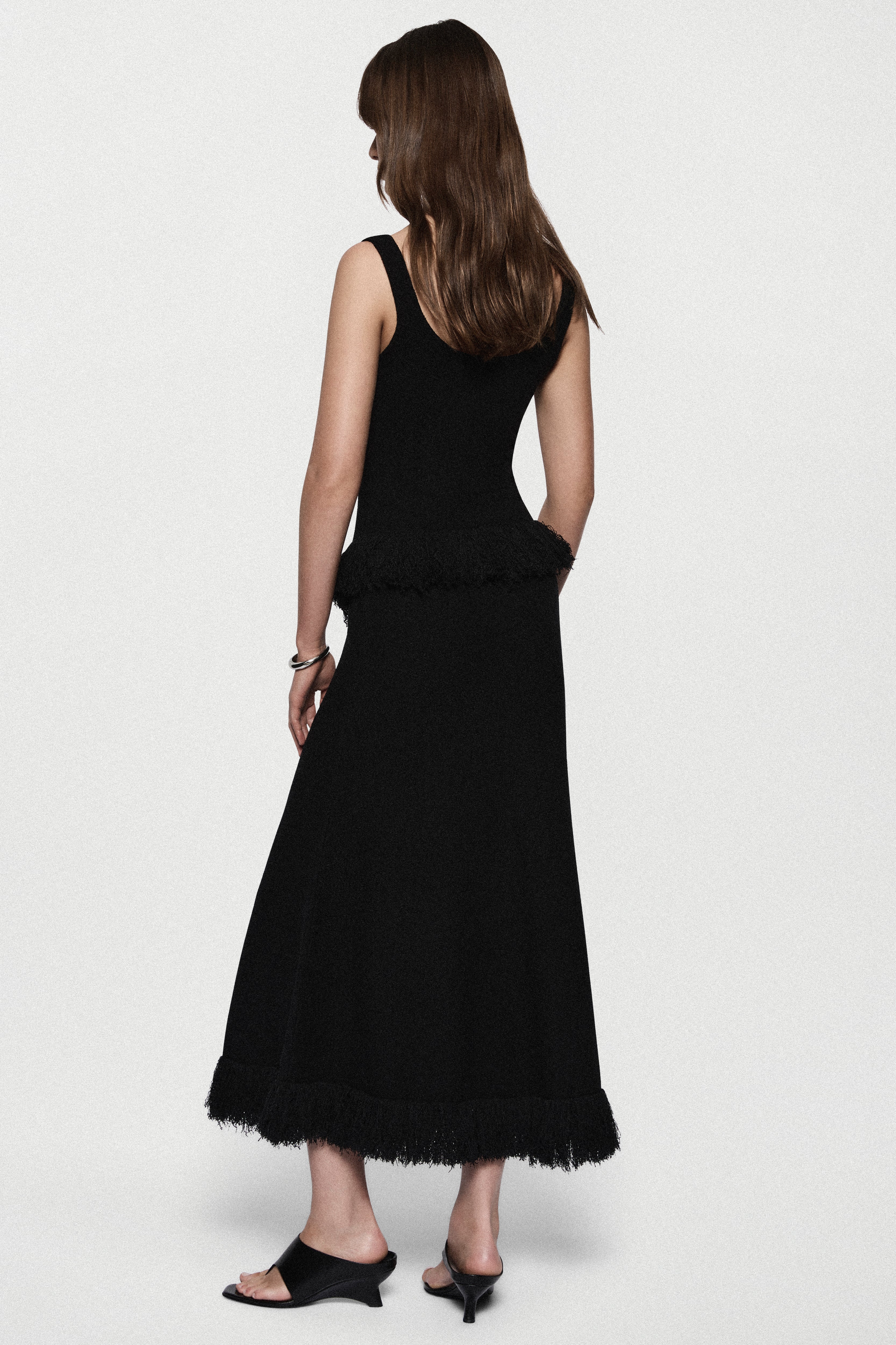 Black boucle midi skirt, back view with fringe hem trim