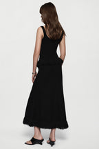 Black sleeveless top with square back and layered fringe hem