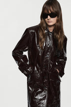 Bitter chocolate patent leather coat with stand collar and button placket detail