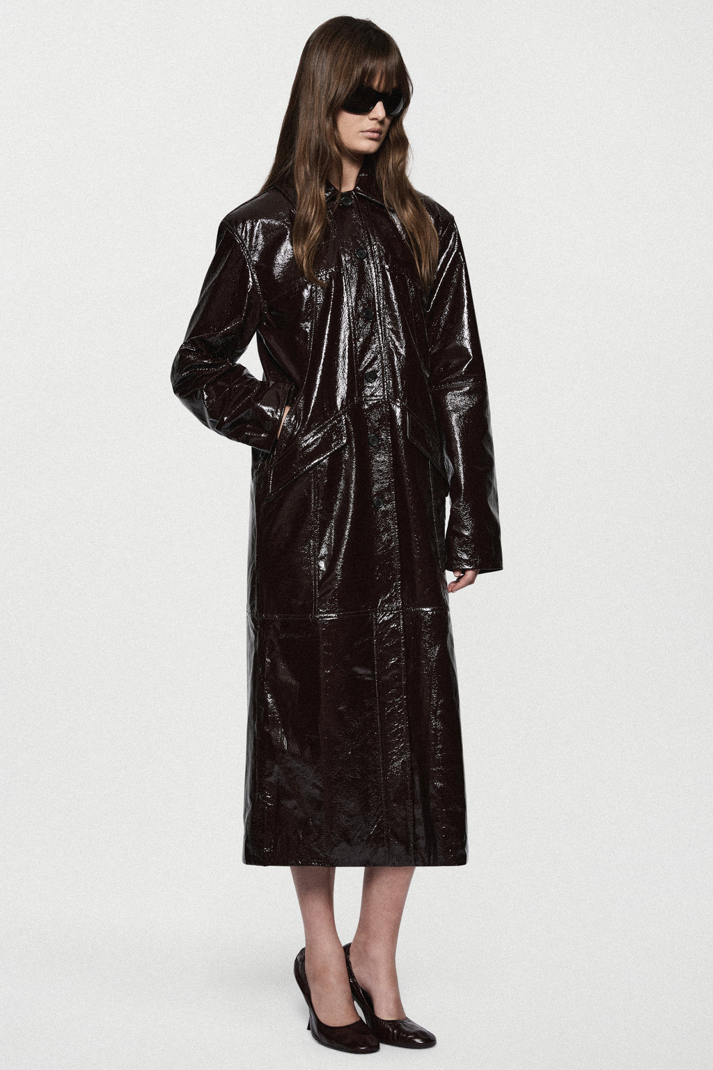 Bitter chocolate patent leather coat, long glossy finish, button front and wide sleeves