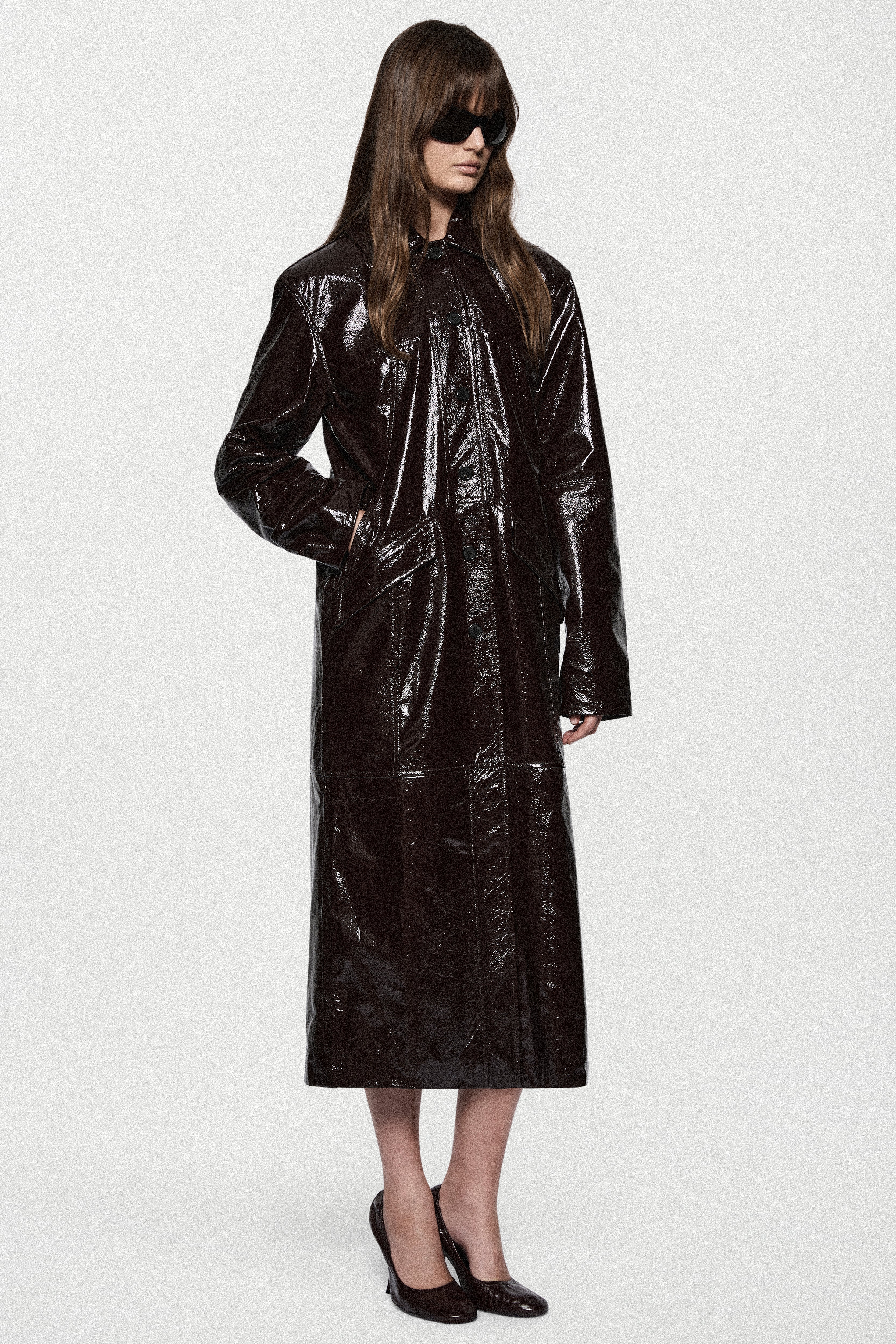 Bitter chocolate patent leather coat, long glossy finish, button front and wide sleeves