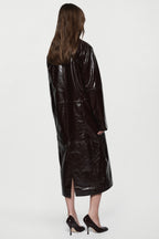 Bitter chocolate patent leather coat, glossy finish, back view with center hem slit