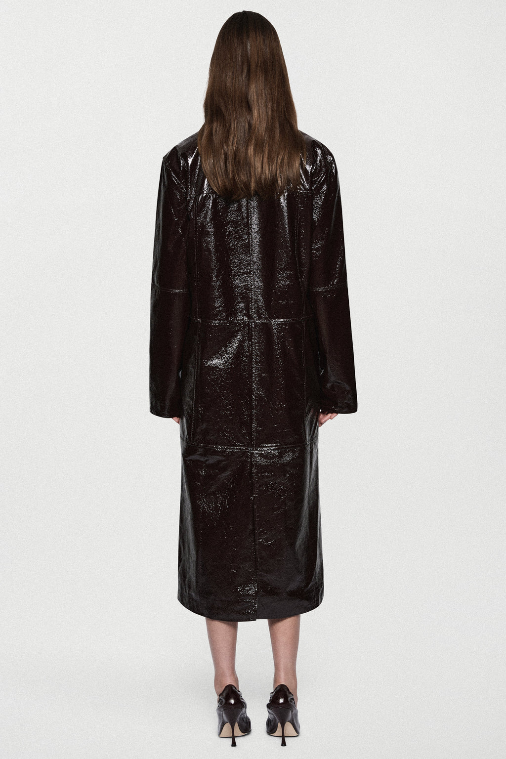 Back view of bitter chocolate patent leather coat, long glossy finish, button details