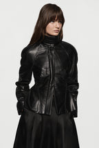 Black leather jacket with stand collar, front zip, and peplum waist detail.