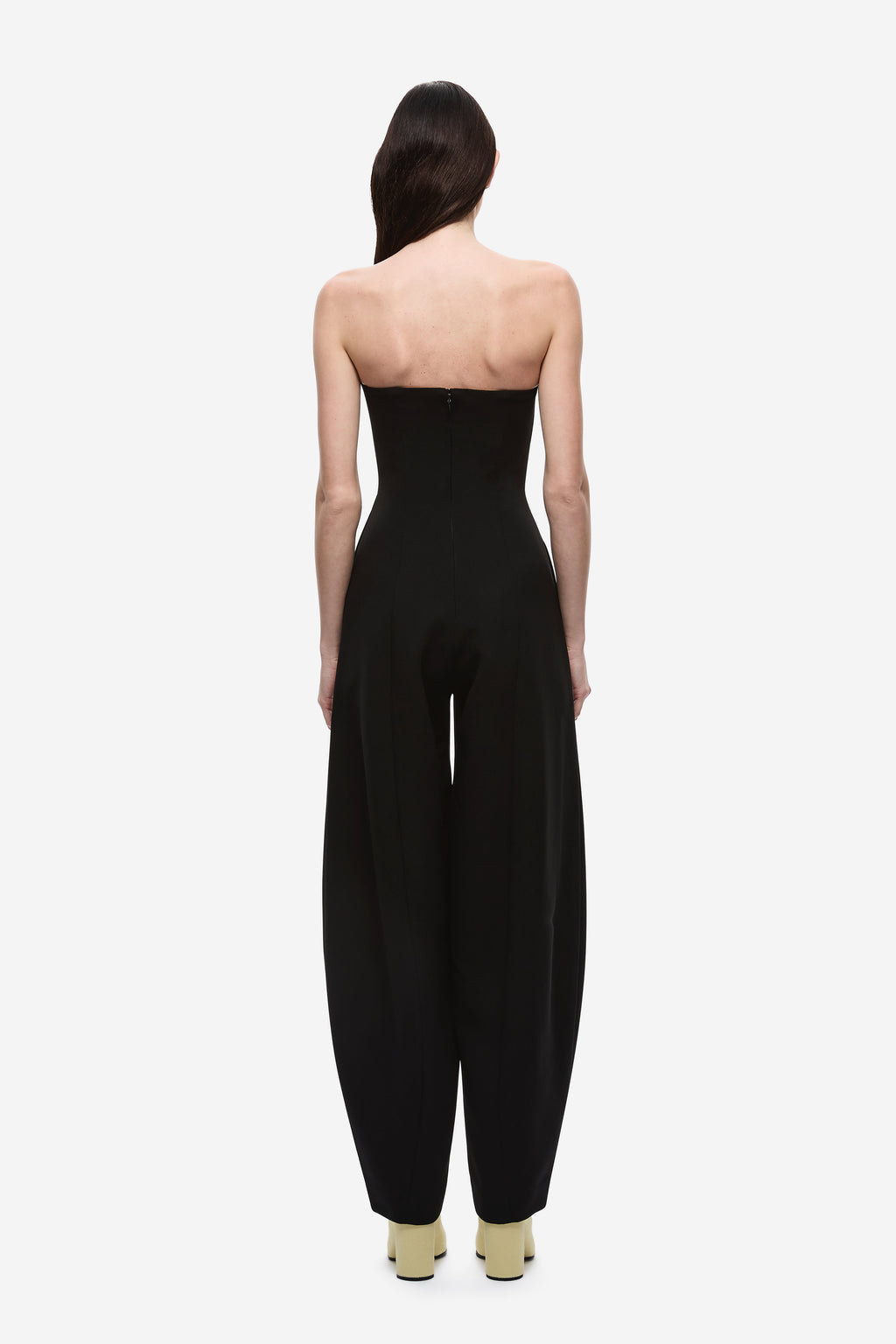Black strapless jumpsuit, back view with long wide legs and center back seam