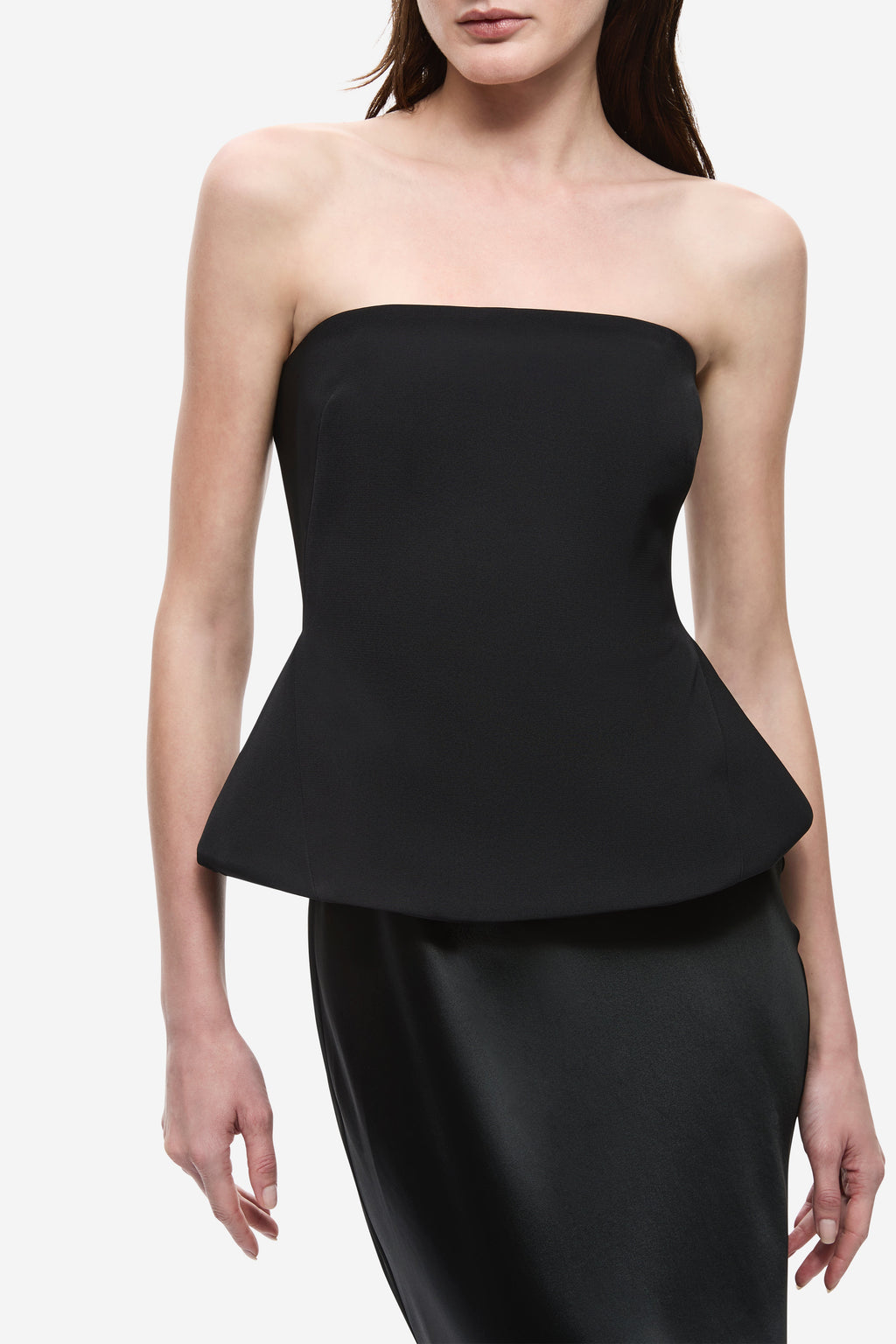 Black strapless satin bodice with padded shape and peplum overlay, close-up