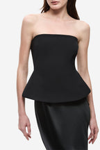 Black strapless satin bodice with padded shape and peplum overlay, close-up