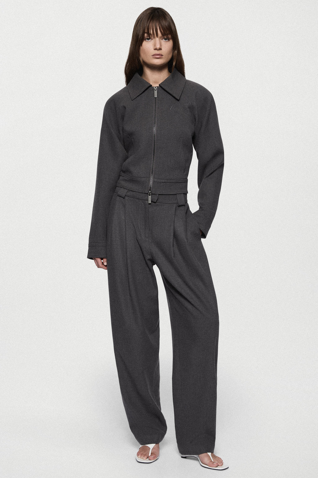 Charcoal tailored trousers with zip fly, belt loops, and tapered straight legs