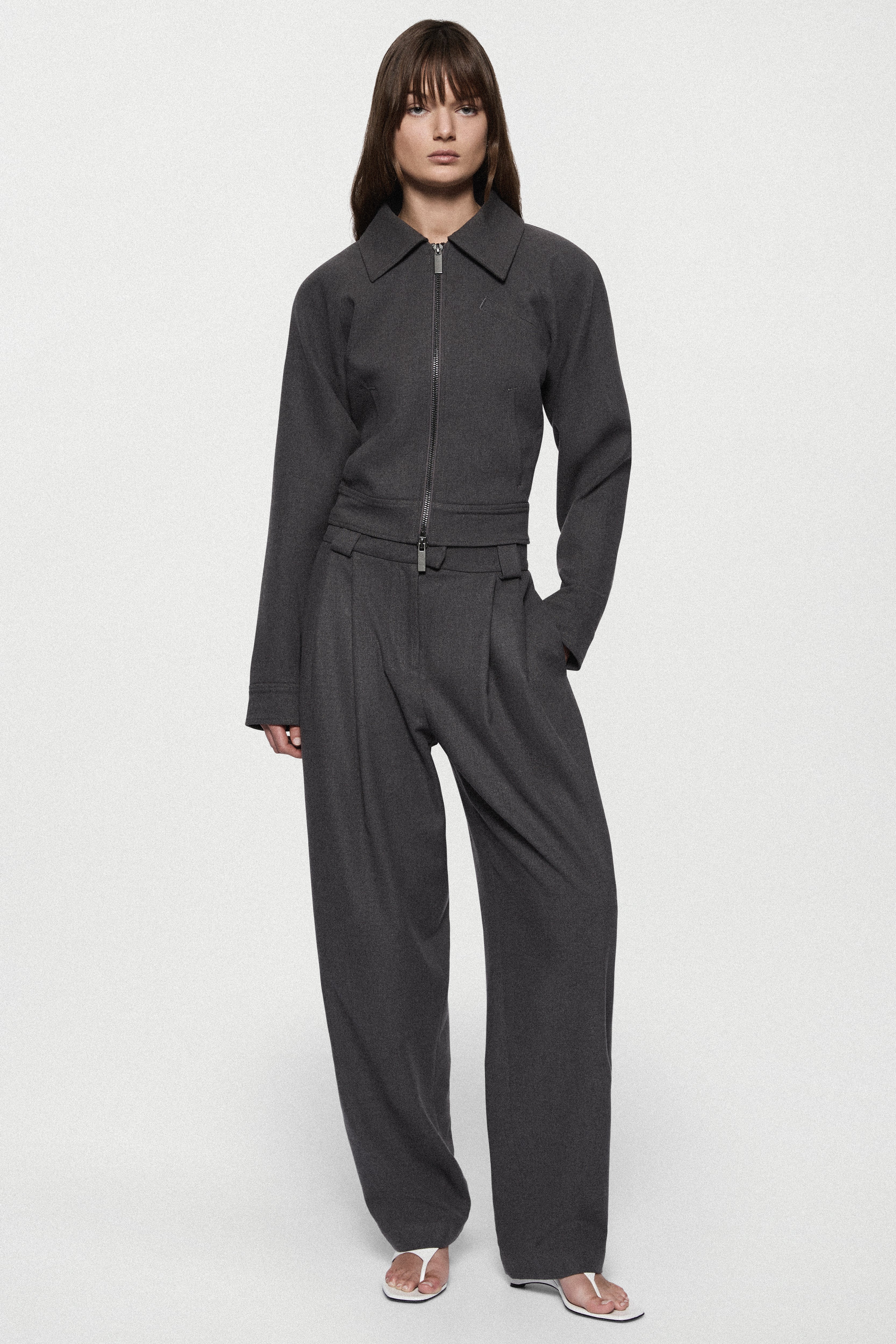Charcoal tailored trousers with zip fly, belt loops, and tapered straight legs