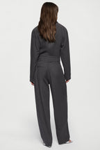 Charcoal tailored trousers, back view with center seam and relaxed wide-leg