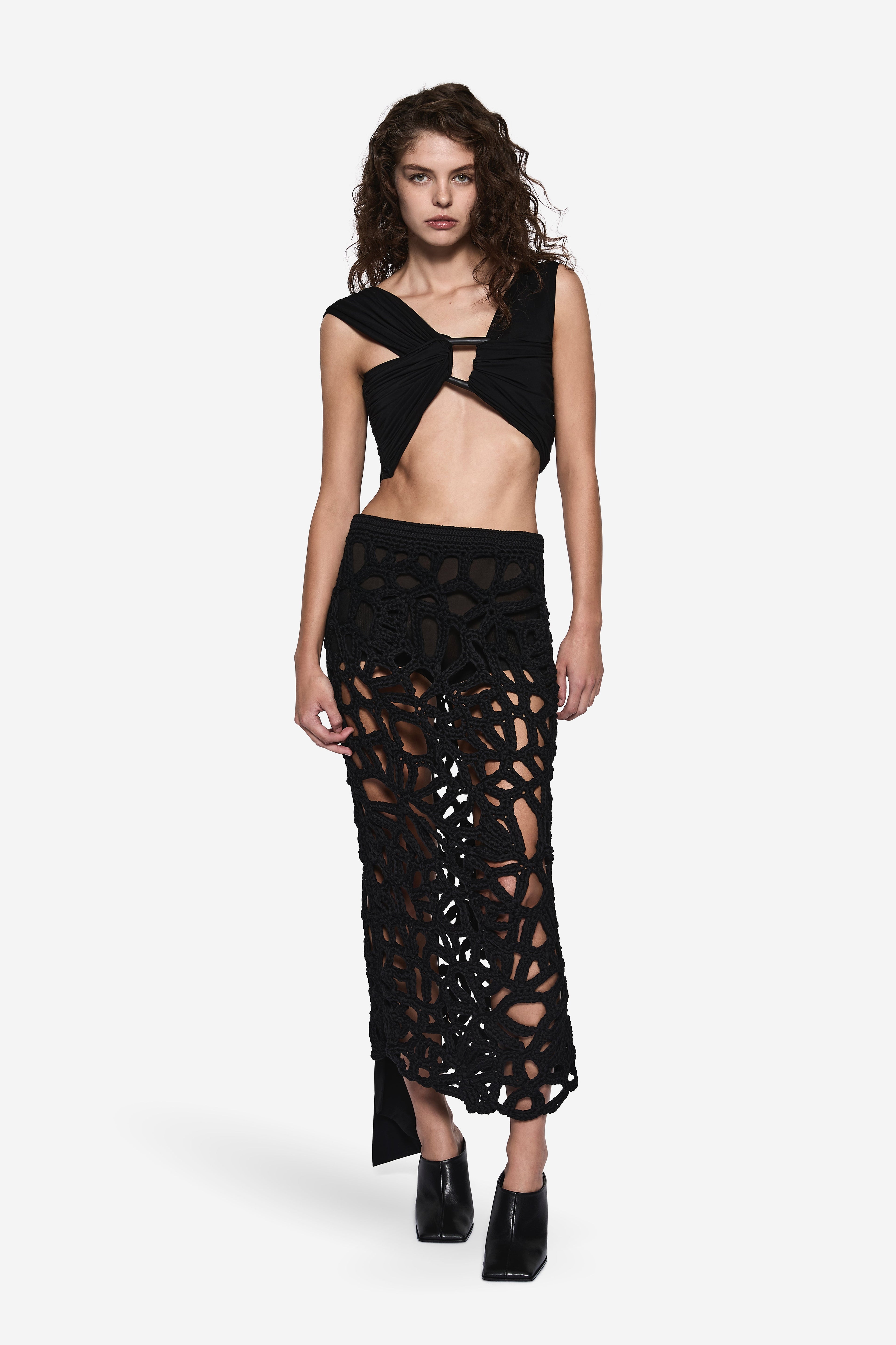 Black sleeveless wrap top with V-shaped wrap front and side cutouts