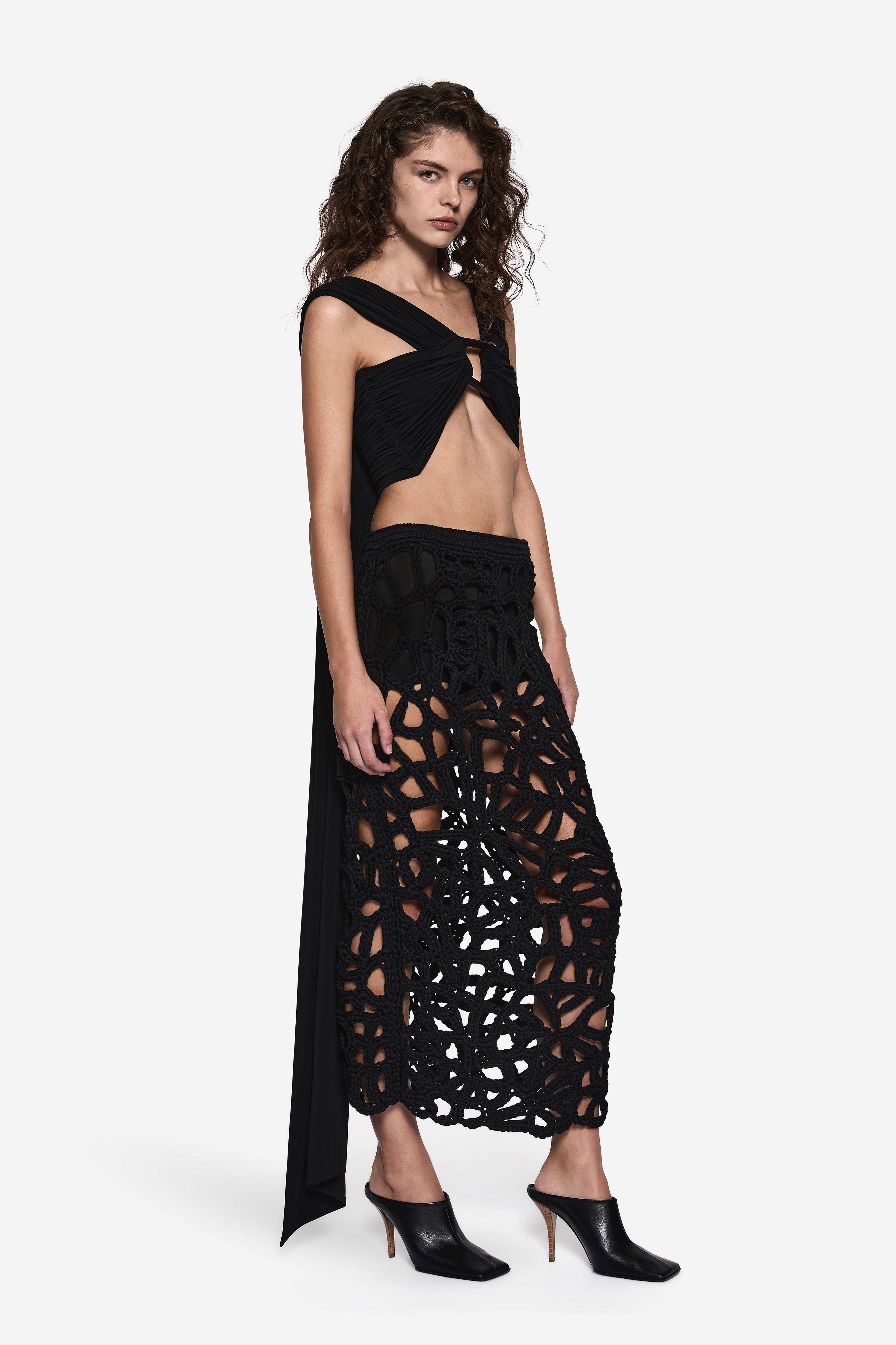 Black sleeveless wrap top with crossed front and open shoulder cutout