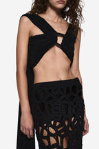 Black sleeveless wrap top with draped crisscross front and waist cutout