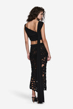 Black sleeveless wrap top with open back and crisscross shoulder straps
